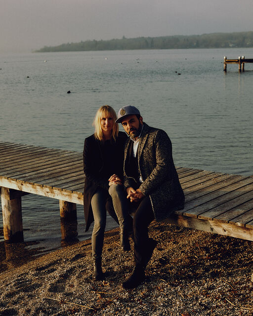 „Wir fühlen uns grandios wohl hier“: Schauspieler Adnan Maral und seine Frau im Interview Franziska und Adnan Maral sitzen auf Holzsteg am Ammersee